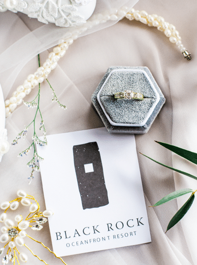 Romantic wedding day details including a vintage bracelet, ring and ring box, and black rock resort stationery