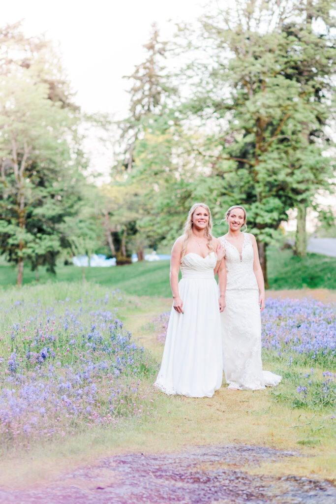 Brides standing in a field of blue wildflowers in Nanaimo